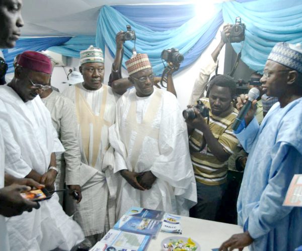 Kano State Deputy Governor, Prof. Hafiz Abubakar (2nd left) and his entourage listen as the Controller, NDIC Kano Zonal Office, Mr. Kabir Oniyangi (1st right) explains the mandate of the NDIC at the 2017 Kano International Trade Fair.